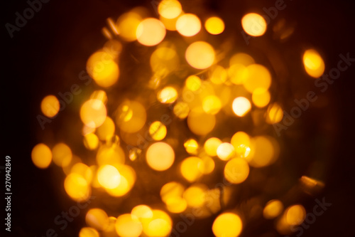 Yellow bokeh lights from the lamp convey warmth, lights on bokeh as background, bokeh light abstract background, Blurred blur, darkness concept