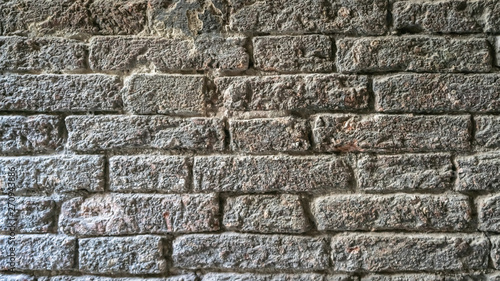 Brick wall. Texture of vintage Grey old wall in Venice. Ancient Bricks Stucco Dark Gray background. Grunge Granite Stone Wall.