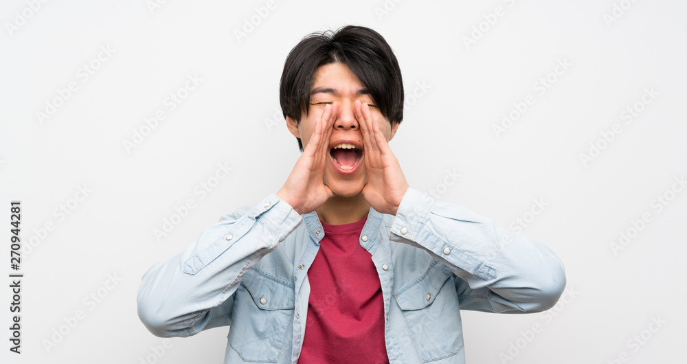 Asian man on isolated white background shouting and announcing something Asian man on isolated white background shouting and announcing something