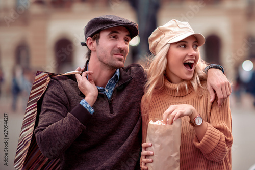 Portrait of a couple with shopping bags in city