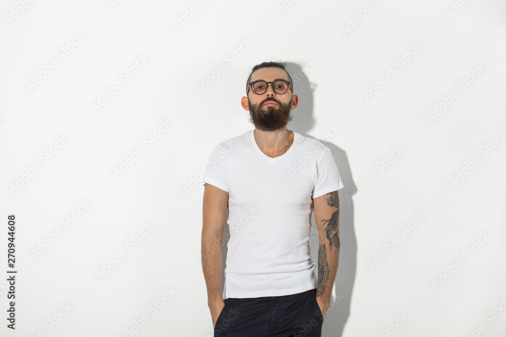 Beauty, fashion and people concept - Cool man with beard posing over white background with copy space Beauty, fashion and people concept - Cool man with beard posing over white background with copy space