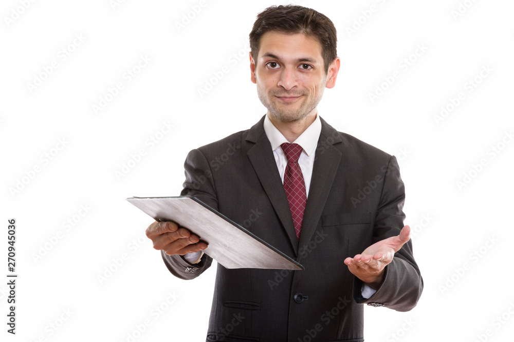 Studio shot of young businessman giving clipboard Studio shot of young businessman giving clipboard