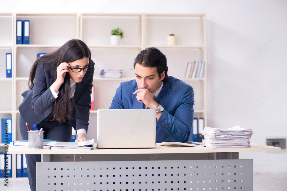 Two employees working in the office Two employees working in the office