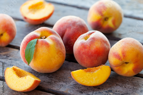 Fresh peaches, fruits on grey wooden background. Close up.