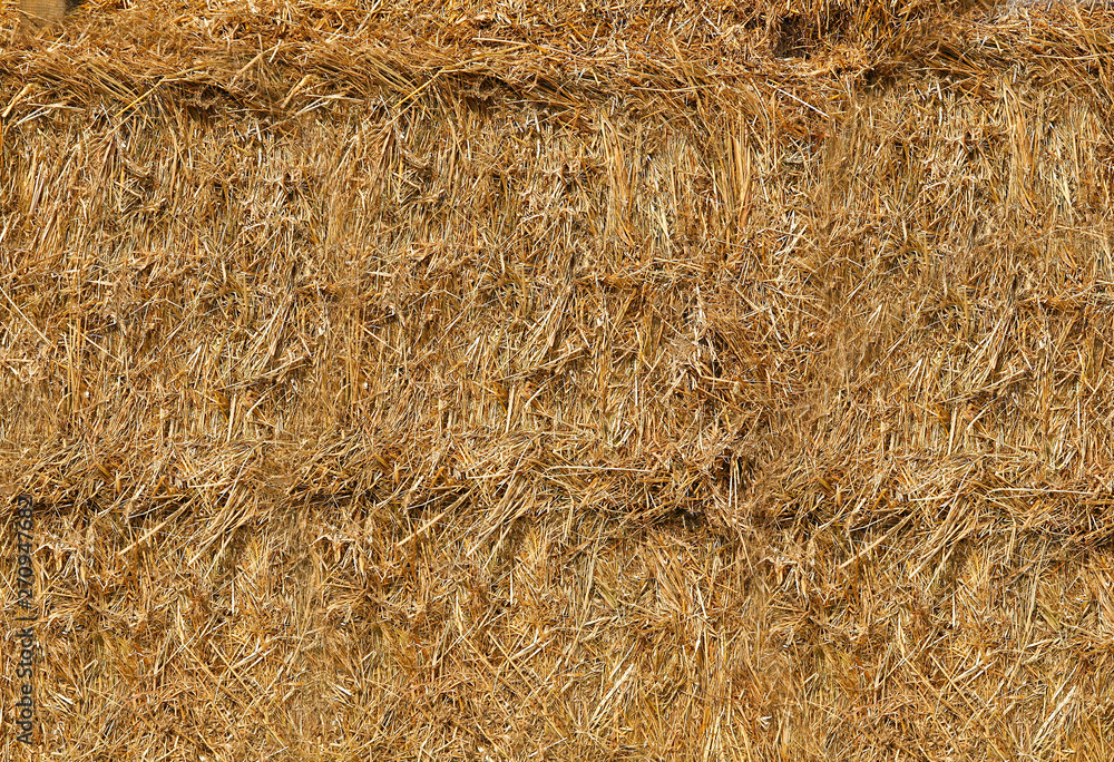 Straw was pressed into large bales lying on top of each other.Texture or background. Straw was pressed into large bales lying on top of each other.Texture or background.