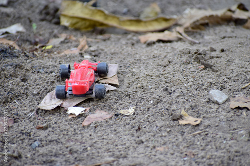 Red toy car on the ground