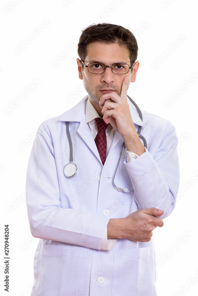 Studio shot of young man doctor wearing eyeglasses while thinkin Studio shot of young man doctor wearing eyeglasses while thinkin