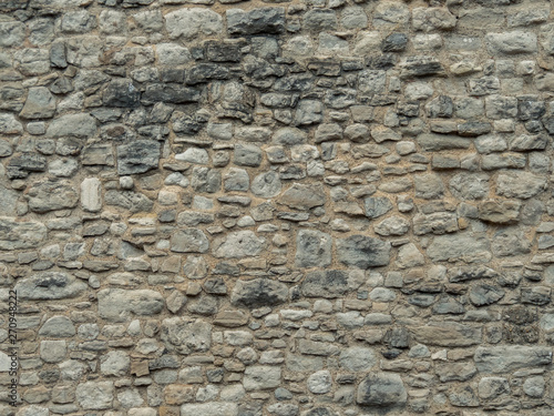 Texture of a stone wall. Old castle stone wall texture background. Stone wall as a background or texture. Part of a stone wall, for background or texture.