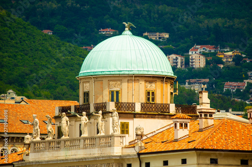 Carciotti palace, Trieste, Italy. The dome and part of the facade and hills in background photo