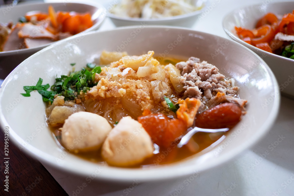 Thai noodle soup tom yum (Kuay Tiew Thai) with minced pork, red pork, pork ball.
