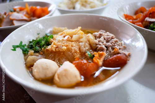 Thai noodle soup tom yum (Kuay Tiew Thai) with minced pork, red pork, pork ball.