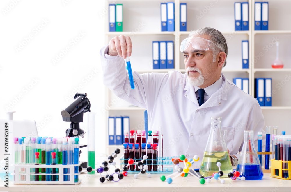 Old male chemist working in the lab Old male chemist working in the lab