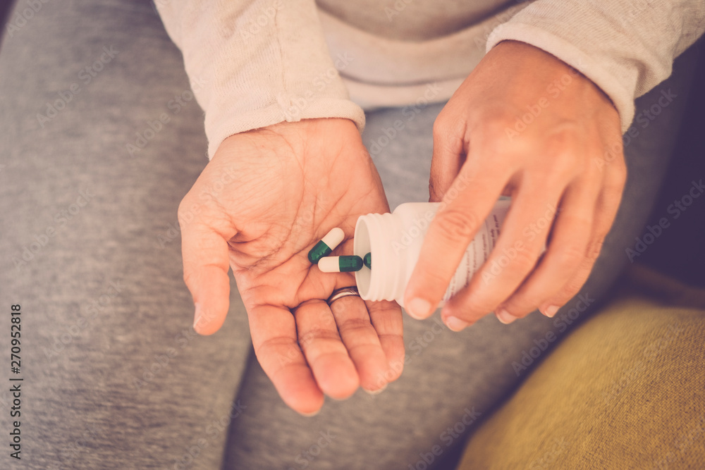 Many colored pills in a womans's hands.. Caring for the health of the elderly - drugs depressing female Many colored pills in a womans's hands.. Caring for the health of the elderly - drugs depressing female