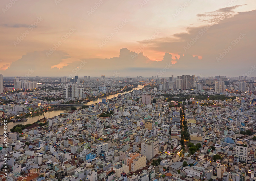 sunset over densely populated area of asian city