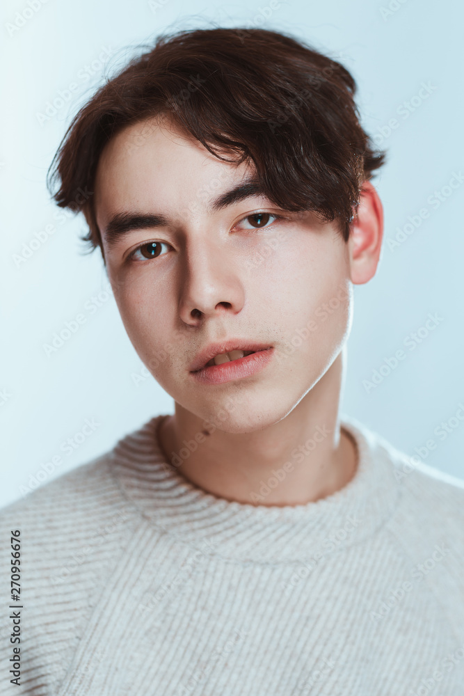 Studio portrait young man in grey sweater on white background Studio portrait young man in grey sweater on white background