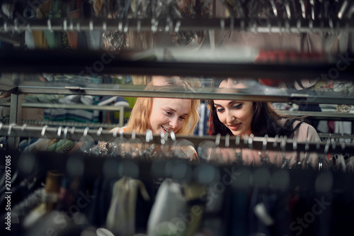 two smiling woman shopping in retail store