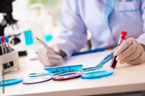 Young female chemist working in the lab 