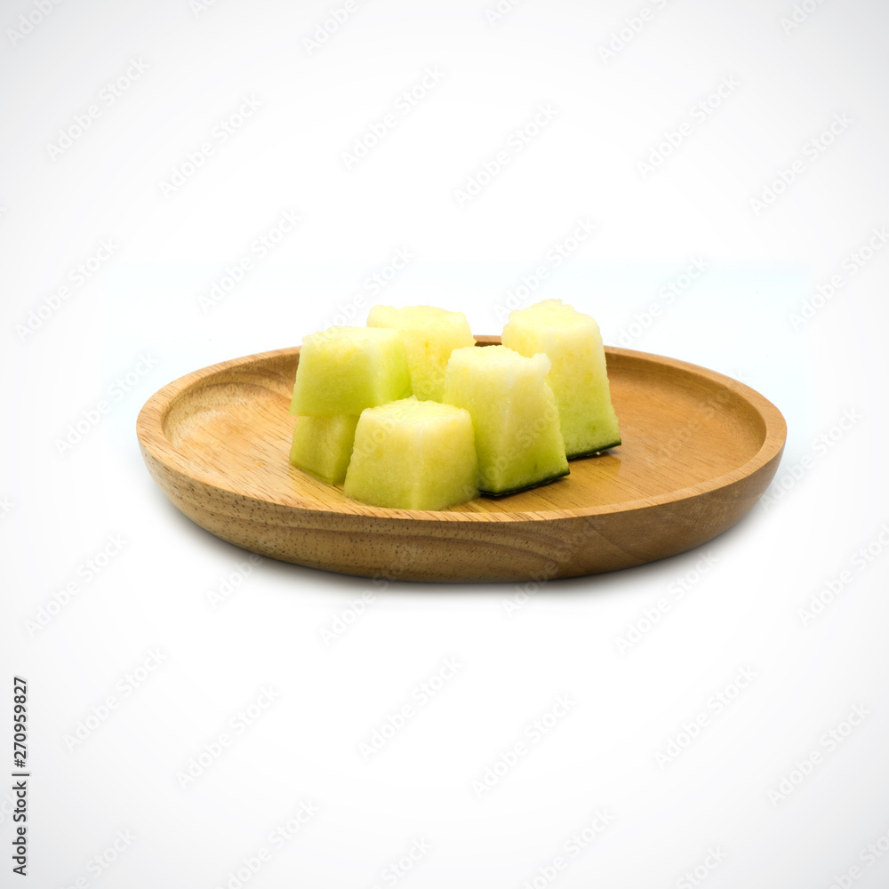 Cantaloupe Melon, In a wooden plate with green flesh on the White Blackground. Cantaloupe Melon, In a wooden plate with green flesh on the White Blackground.