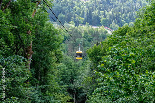 cable car crossing valley of Gauja in Sigulda, Latvia in green summer