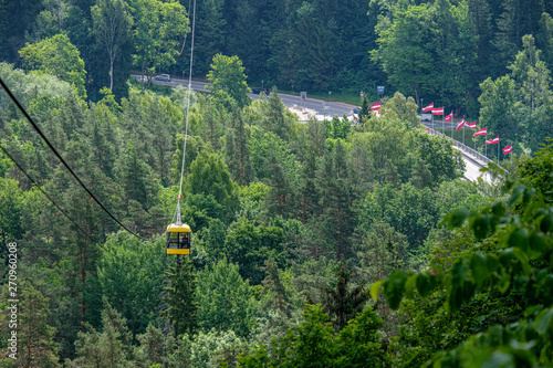 cable car crossing valley of Gauja in Sigulda, Latvia in green summer