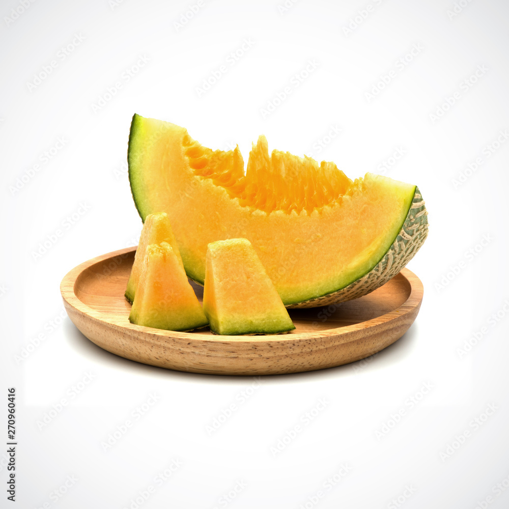 Cantaloupe Melon, In a wooden plate with Orange flesh on the White Blackground. Cantaloupe Melon, In a wooden plate with Orange flesh on the White Blackground.
