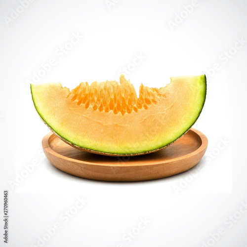 Cantaloupe Melon, In a wooden plate with Orange flesh on the White Blackground.
