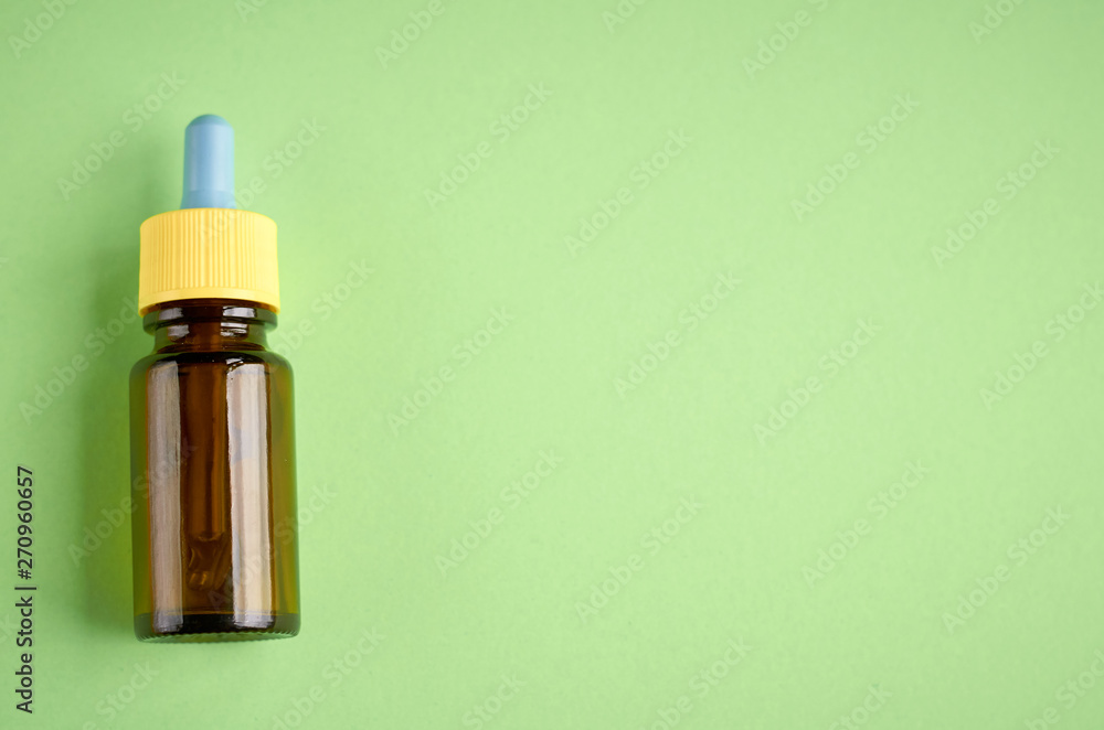 Nasal drops bottle composition, glass bottle green background Nasal drops bottle composition, glass bottle green background