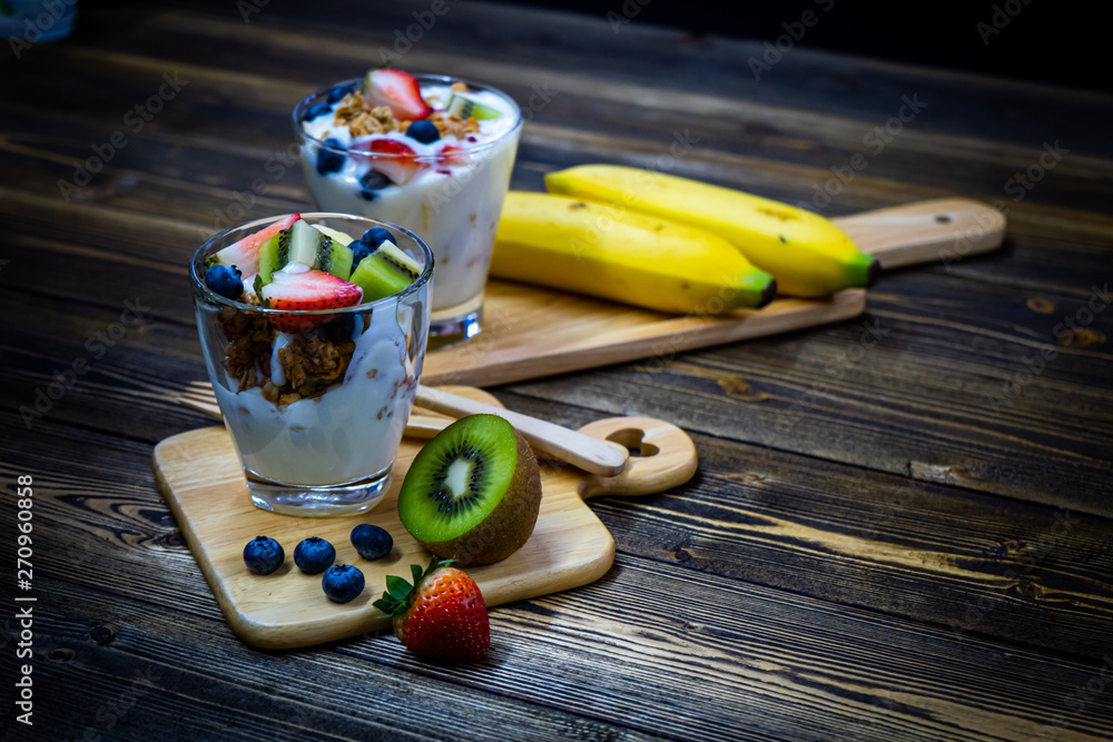 Snacks with yogurt, muesli and fresh berries, fresh kiwi, fresh strawberries,  healthy food and good weight loss.