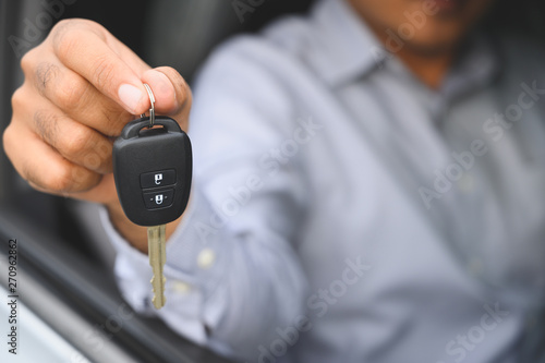 Businessman giving a car key. Getting new car concept.