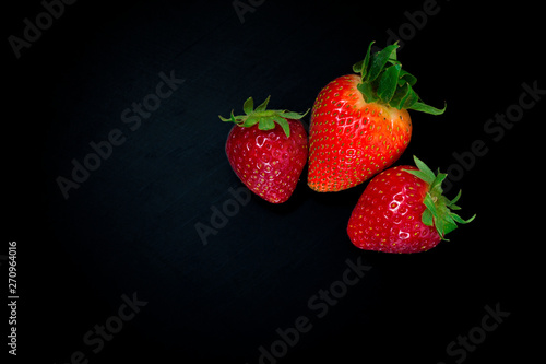 strawberry berries on a black background. From above. Isolated on black