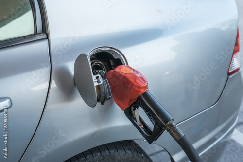 Pumping gasoline fuel in car at gas station © Nopphon