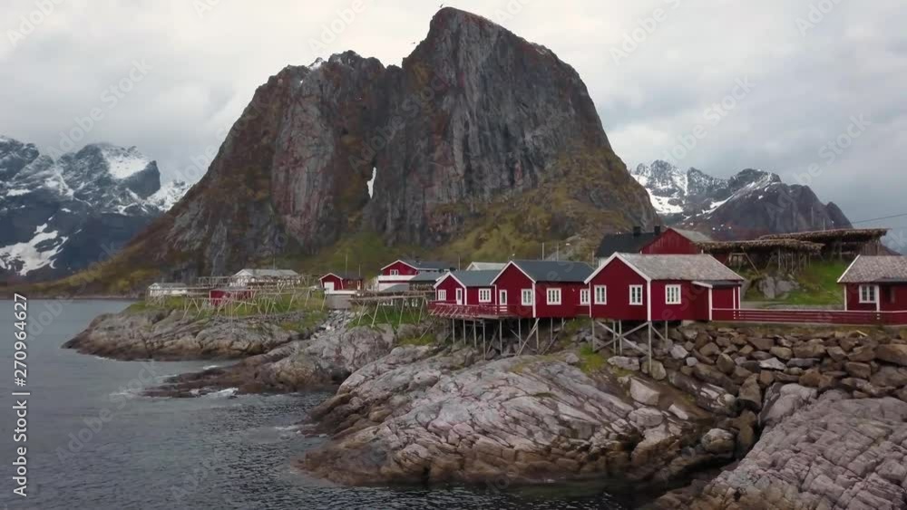 Aerial footage of small fishing village on Lofoten islands in Norway, popular tourist destination with its typical red houses