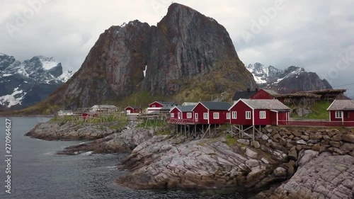 Aerial footage of small fishing village on Lofoten islands in Norway, popular tourist destination with its typical red houses photo