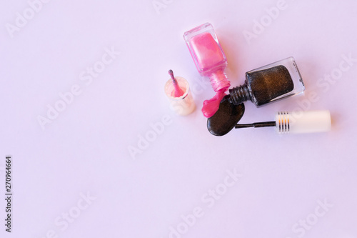 nail polish and lipstick on pink background
