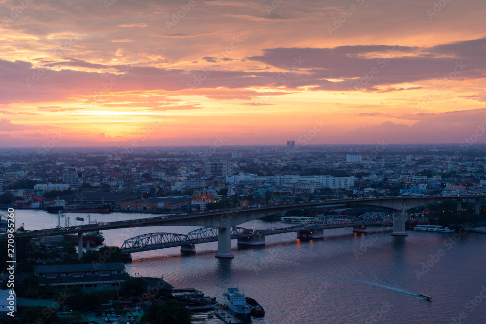 Bangkok city scape at Thonburi side during sunset with Chaophraya river view.