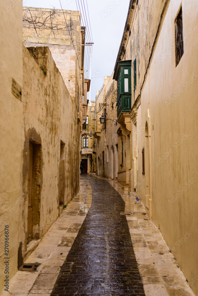 Wet, narrow, cobbled streets in Victoria, Gozo, Malta following a heavy rain storm.
