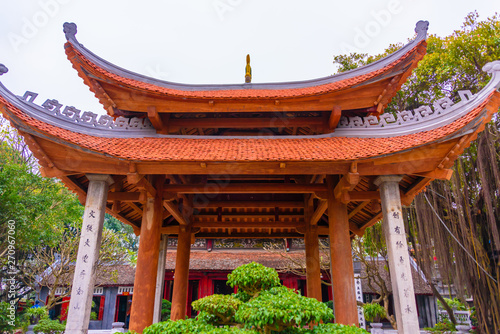 Very old bonsai tree on display outside the pergoda at Den Ngoc Son Confucious Temple at Ho Hoan Kiem lake, Hanoi, Vietnam photo