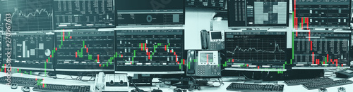 Display of Stock market quotes and chart in monitor computer room with business office equipments for business and money concept, panorama