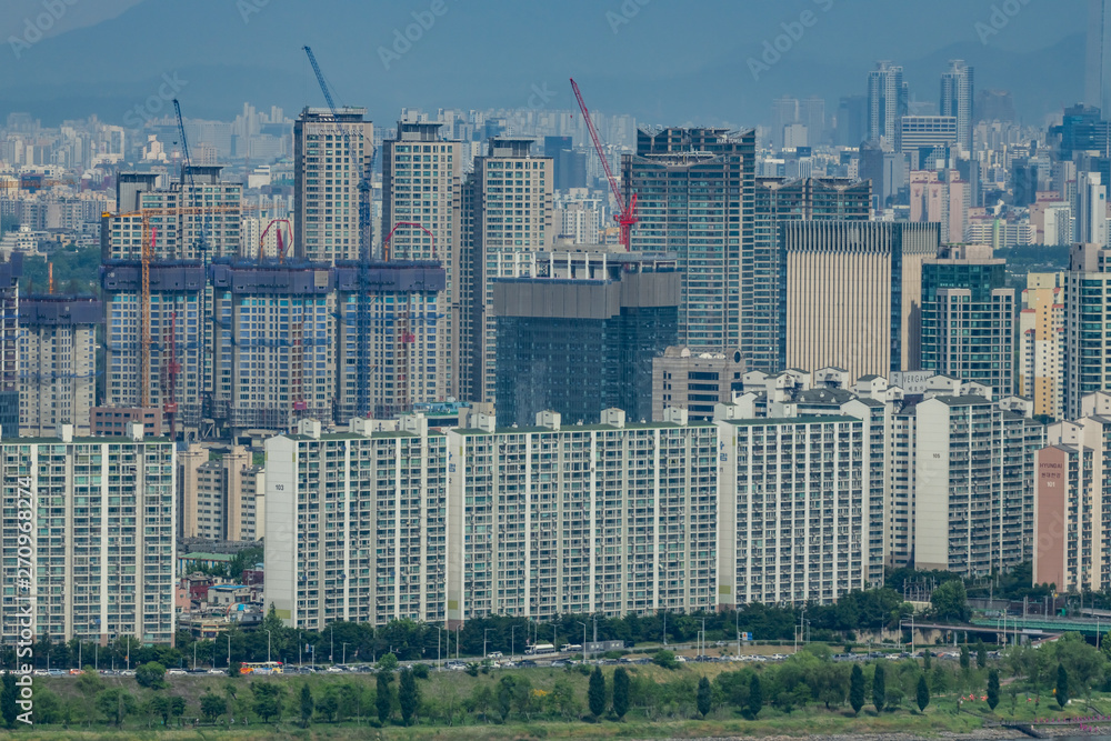 Apartment complexes facing Han River in Seoul, the greyest city in South Korea. High-rise buildings are continuously constructed with increasing population.