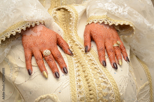 Close-Up Of Hands With Henna Tattoo Against  Background photo