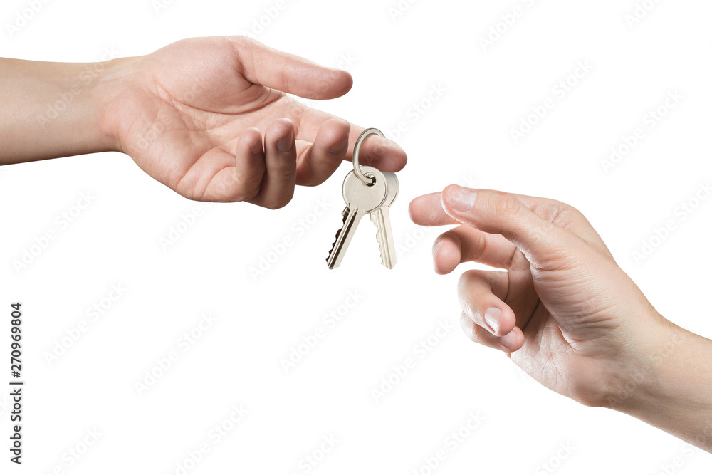 Hands of two people, giving and taking keys, isolated on white background Hands of two people, giving and taking keys, isolated on white background