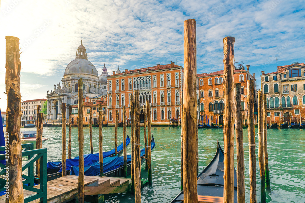 view of the Grand Canal and Basilica Santa Maria della Salute during sunrise with gondolas, Venice, Italy