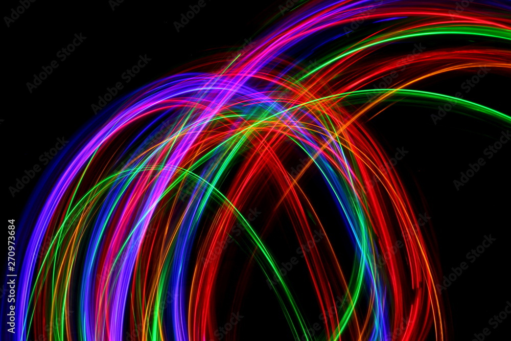 Long exposure, light painting photography. Multi color streaks and swirls of red, green and blue light against a black background. Long exposure, light painting photography. Multi color streaks and swirls of red, green and blue light against a black background.