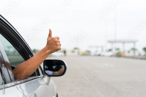 Male hand thumbs up in car