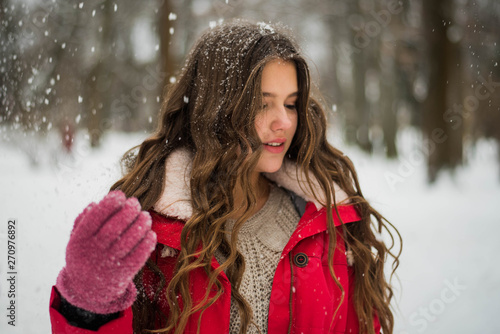 Everything is OK! Outdoor close up portrait of young beautiful happy smiling tenage girl Model looking at camera, wearing stylish winter clothes. Christmas, new year, concept. Snowfall photo