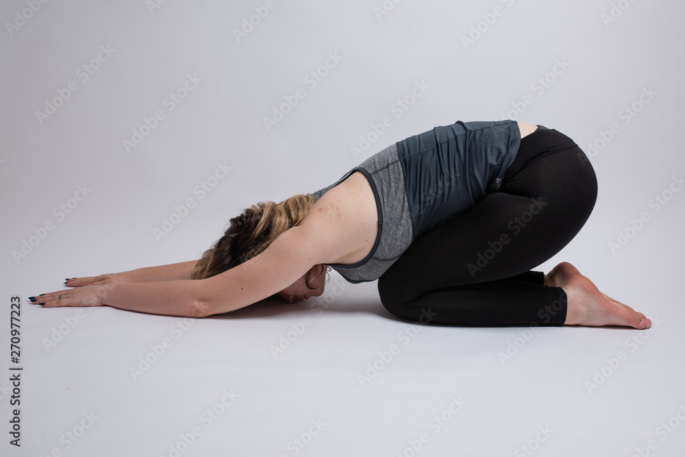 Ardha Kurmasana Half Tortoise yoga pose done by a woman Ardha Kurmasana Half Tortoise yoga pose done by a woman