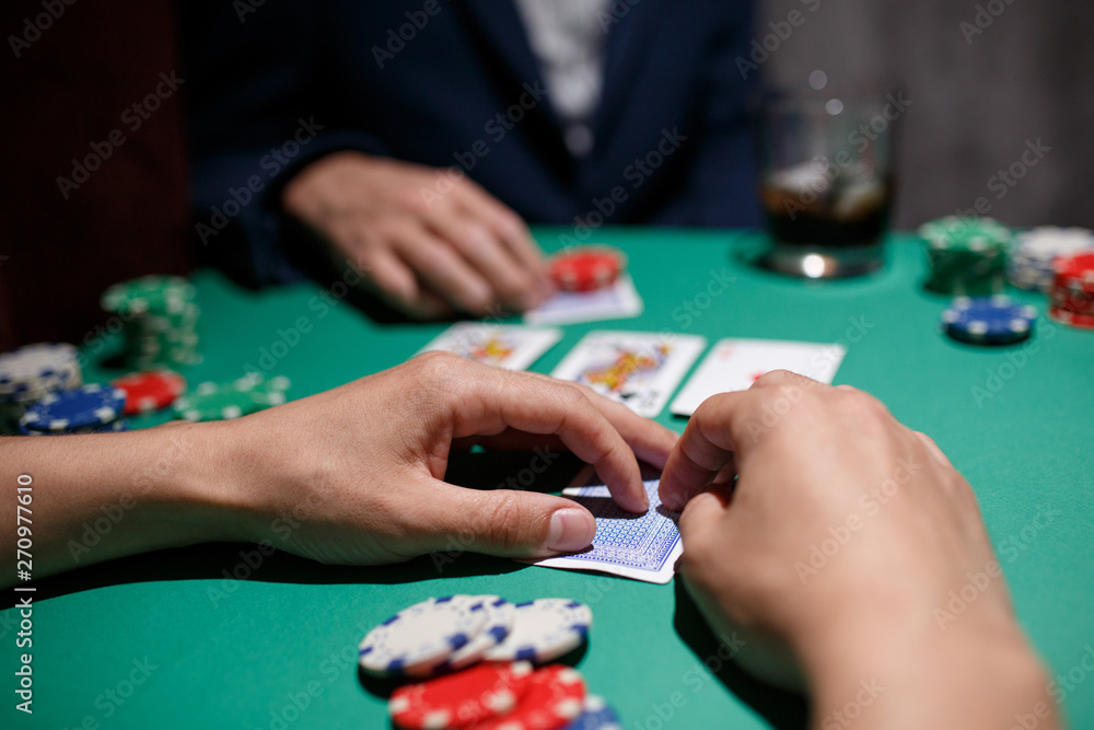 Poker Aces pair .green poker table with top pair. casino gambling. playing cards close-up. poker player watching his hand Poker Aces pair .green poker table with top pair. casino gambling. playing cards close-up. poker player watching his hand