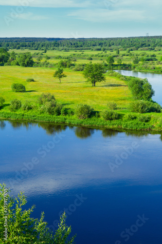 Landscape. Nature. River. Meadow. Green grass. Blue sky with clouds