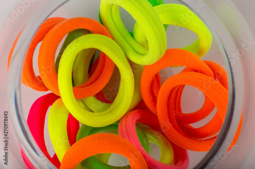 Colored bright children's hair ties on a white background.