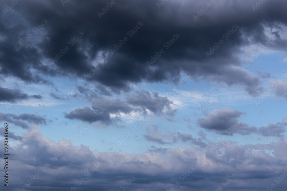 Fototapeta premium Cumulus epic scenic storm clouds in the blue sky background texture